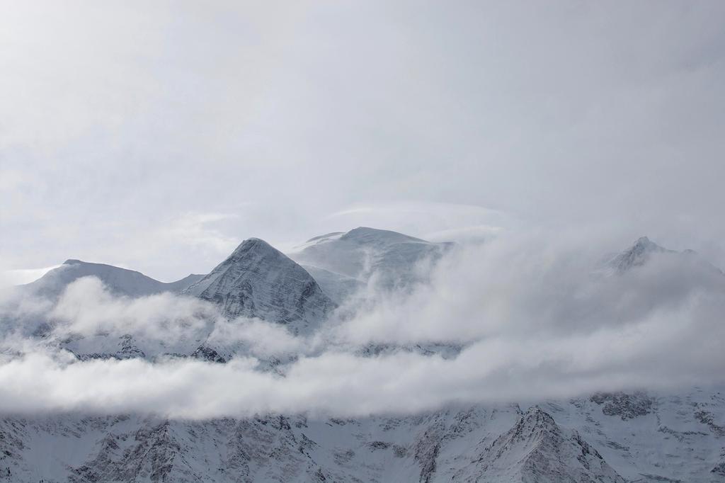 Snow-capped mountain peaks against blue sky