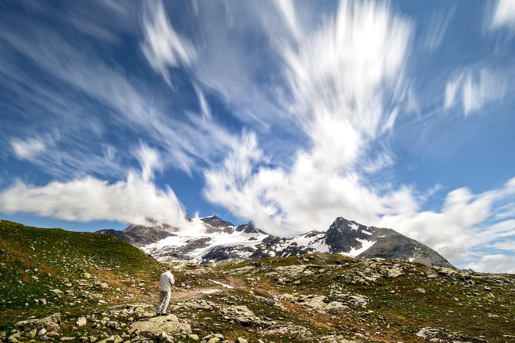 Hiker ascending rocky mountain trail